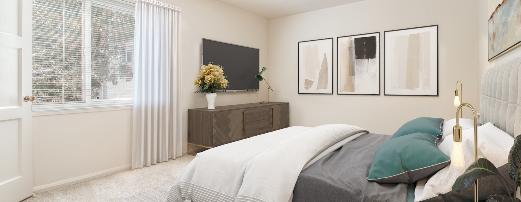 a bedroom with a bed, tv and a table