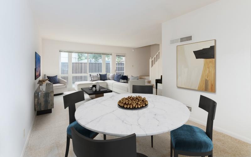 a living room with a couch, tables and chairs